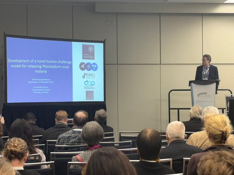 A Photo of Andrew Duncan presenting on stage.